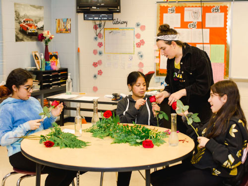 community teacher teaches On the Road youth about floristry