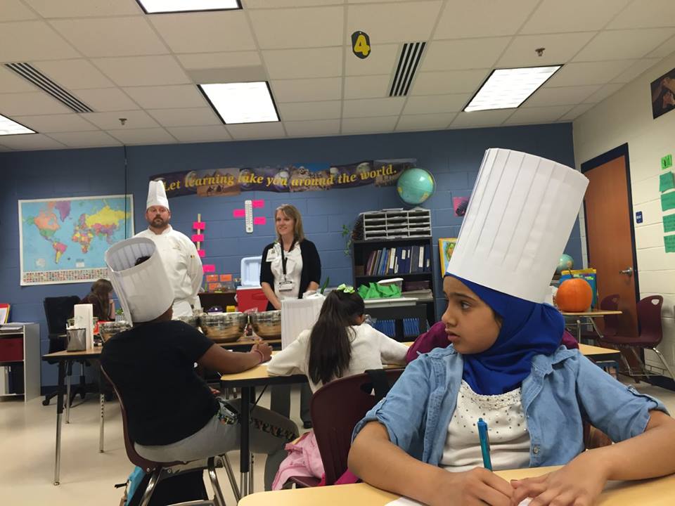 Mays wears a chef hat during an On the Road program